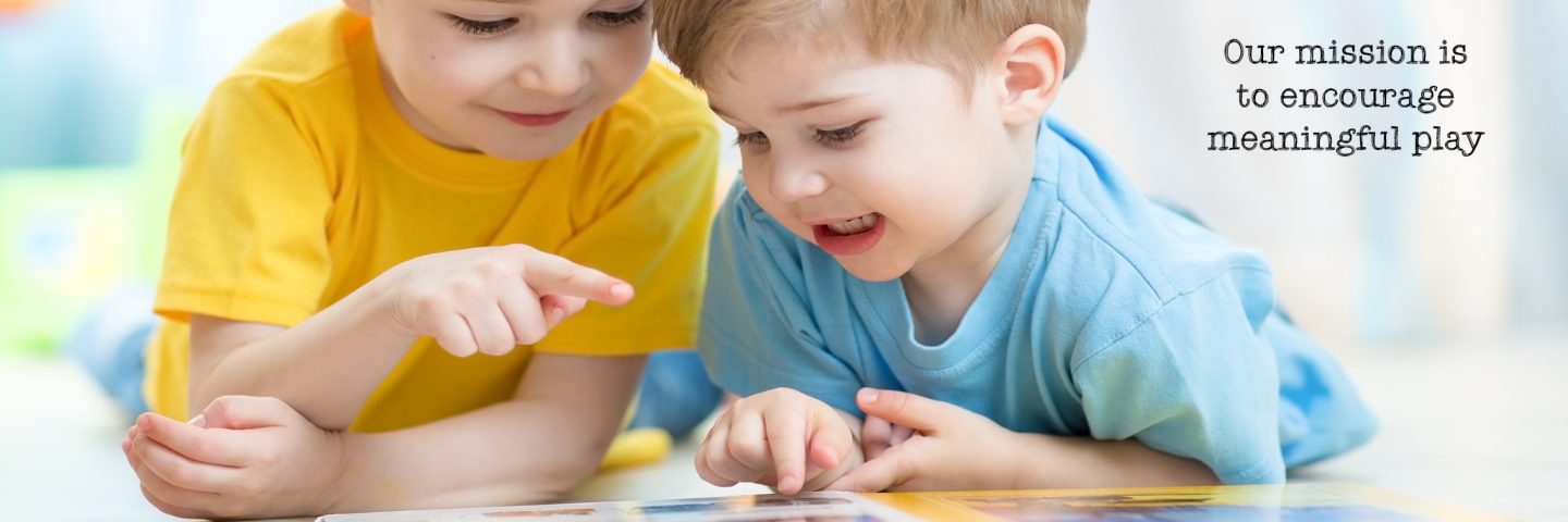 Two boys read a book